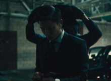 A man looks at his phone unaware he's about to get his head covered in film Take the Night