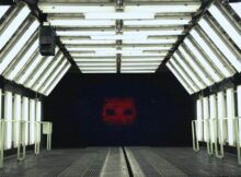 a huge screen showing a robotic face in film Project Dorothy