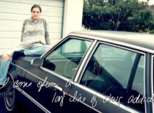 Michelle sits in th trunk of a car in the documentary spyral