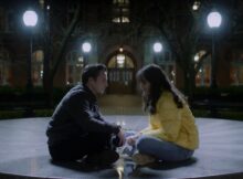A man and a woman face each other while sitting on the floor in the film Step Back Doors Closing