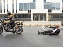 a man is chained to a motorcycle and he tries to shoot the driver in Jasper