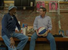 two men speak in the documentary The Waiting Game