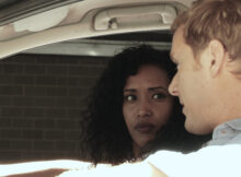 a couple of detectives sit in a car in Model Behaviour