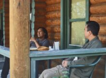 two talking to each other on the porch in the film the birds who fear death