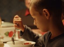 a boy eating in the short film izidor