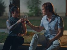 a man and a woman toast in Hold Me Softly