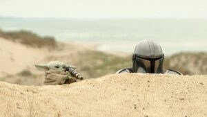 Grogu and Din Djarin during a stakeout in a scene from ‘The Mandalorian and Grogu’.