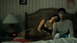 Nikki (Inde Navarrette) and Bear (Michael Johnston) in bed.
